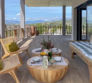 Le canapé extérieur sur le balcon, agrémenté de sa table basse et dressé pour le petit déjeuner.
